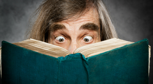 Senior reading open book, surprised old man, amazing eyes looking blank cover
